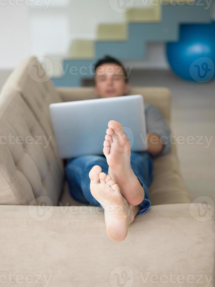 Man using laptop in living room photo