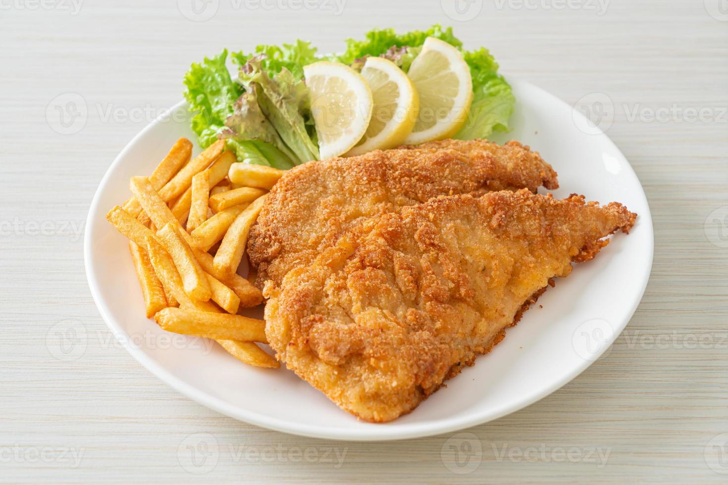 Homemade Breaded Weiner Schnitzel with Potato Chips photo