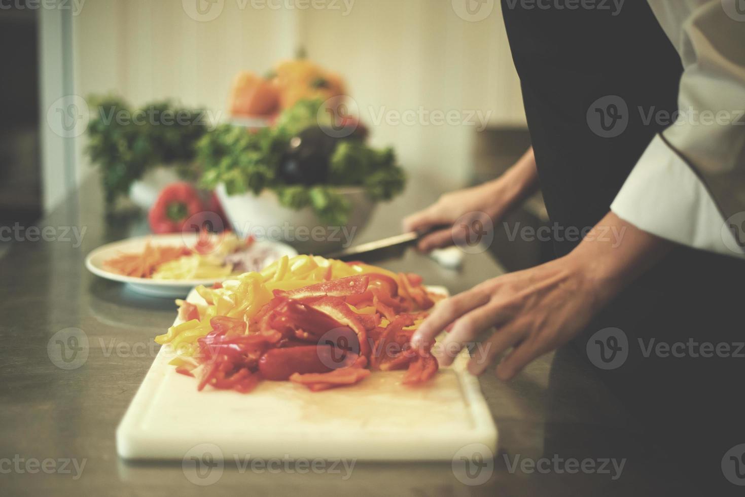 Chef cutting fresh and delicious vegetables photo