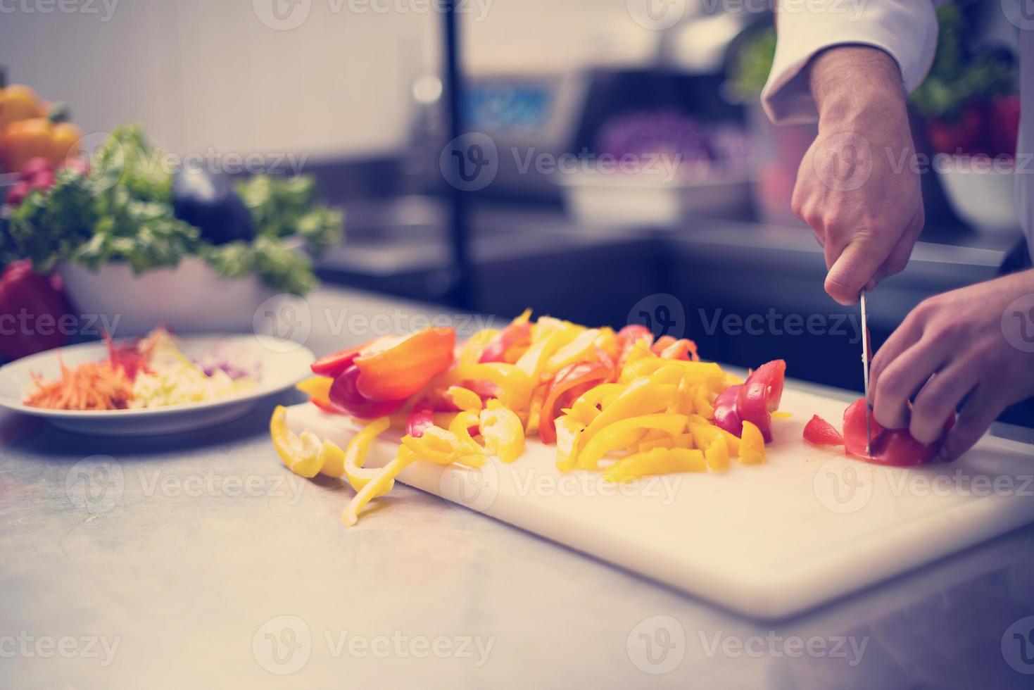 Chef cutting fresh and delicious vegetables photo