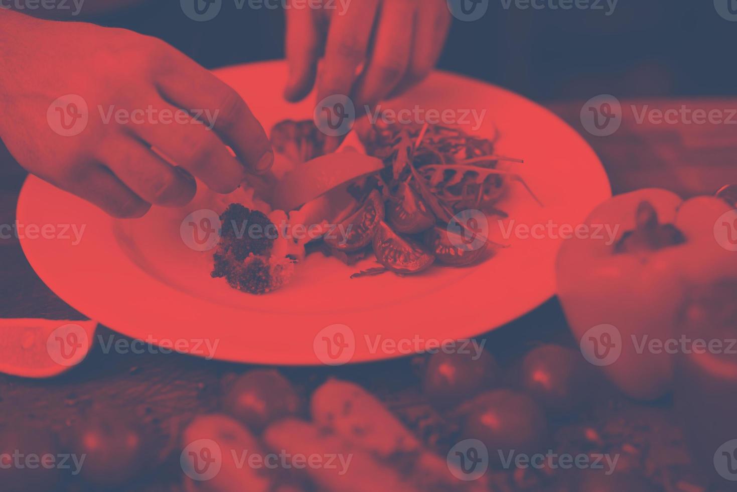 chef serving vegetable salad photo