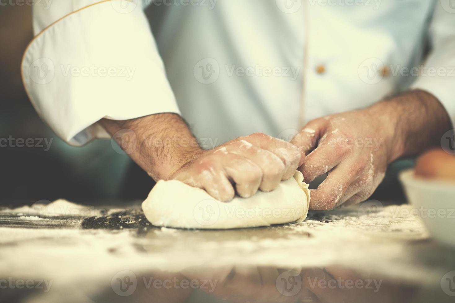 chef hands preparing dough for pizza photo