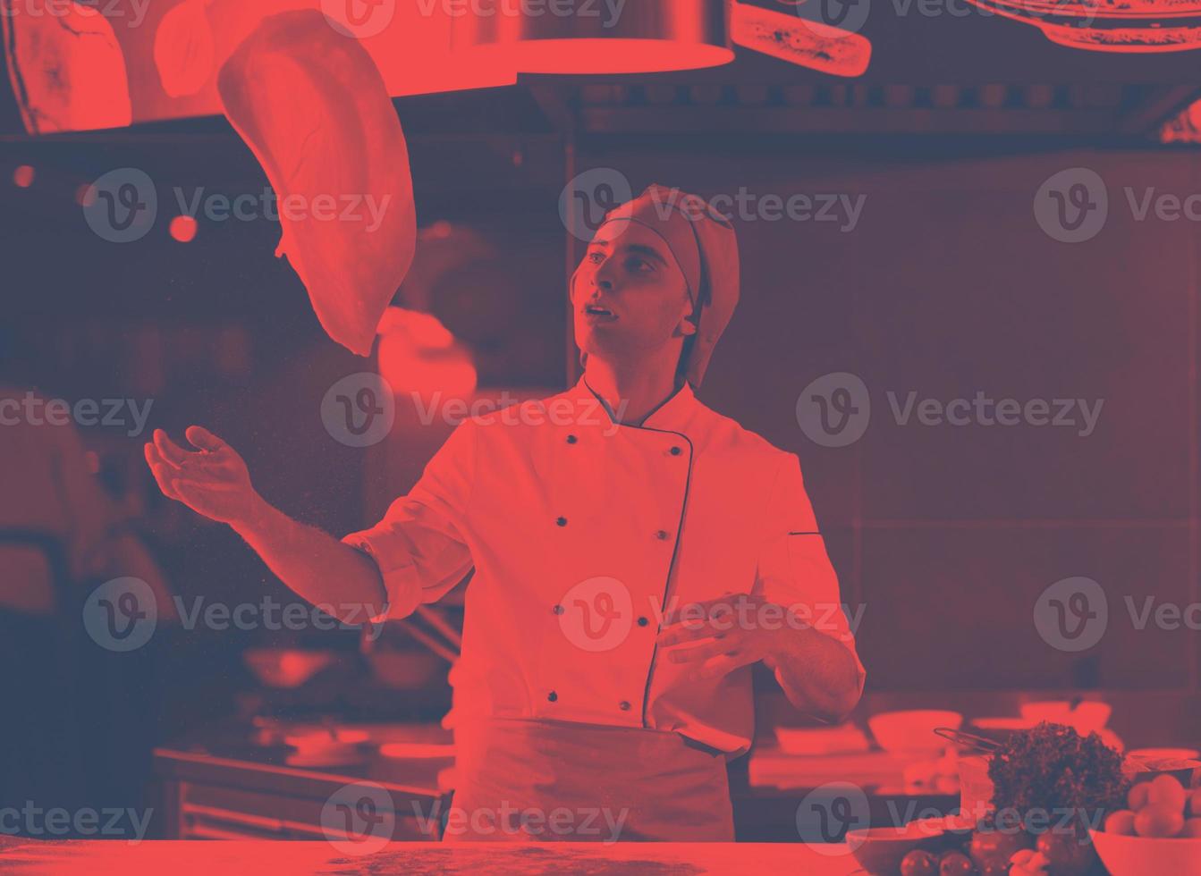 chef throwing up pizza dough photo