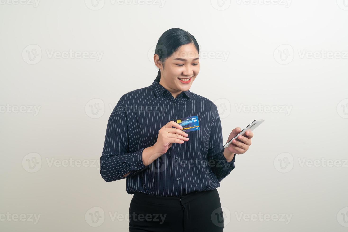 Asian woman using smartphone with hand holding credit card photo