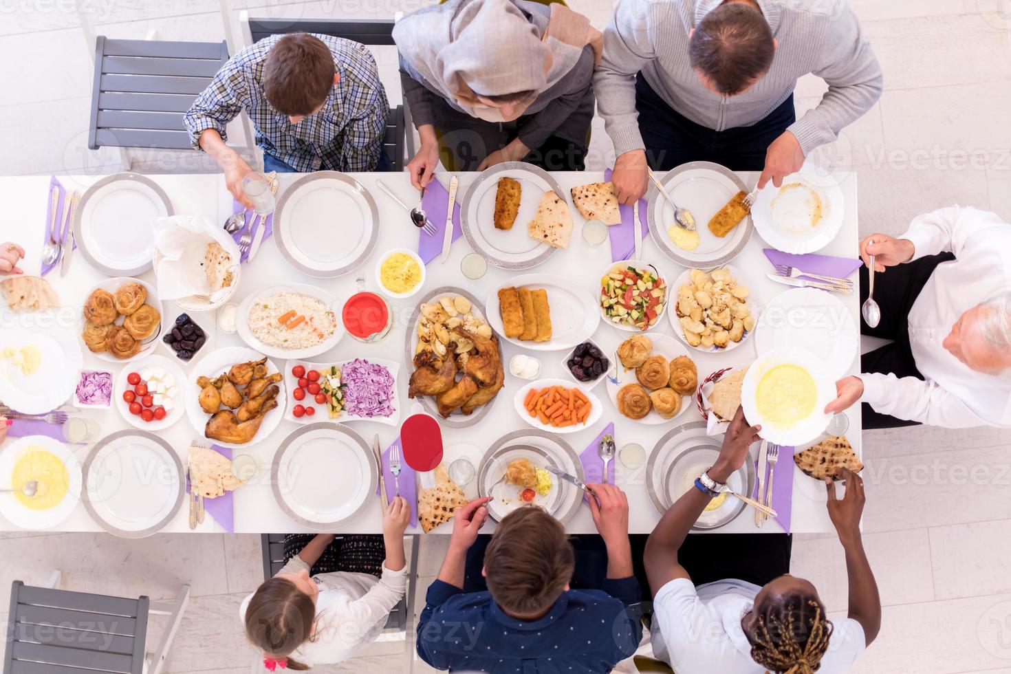 top view of modern multiethnic muslim family having a Ramadan feast photo