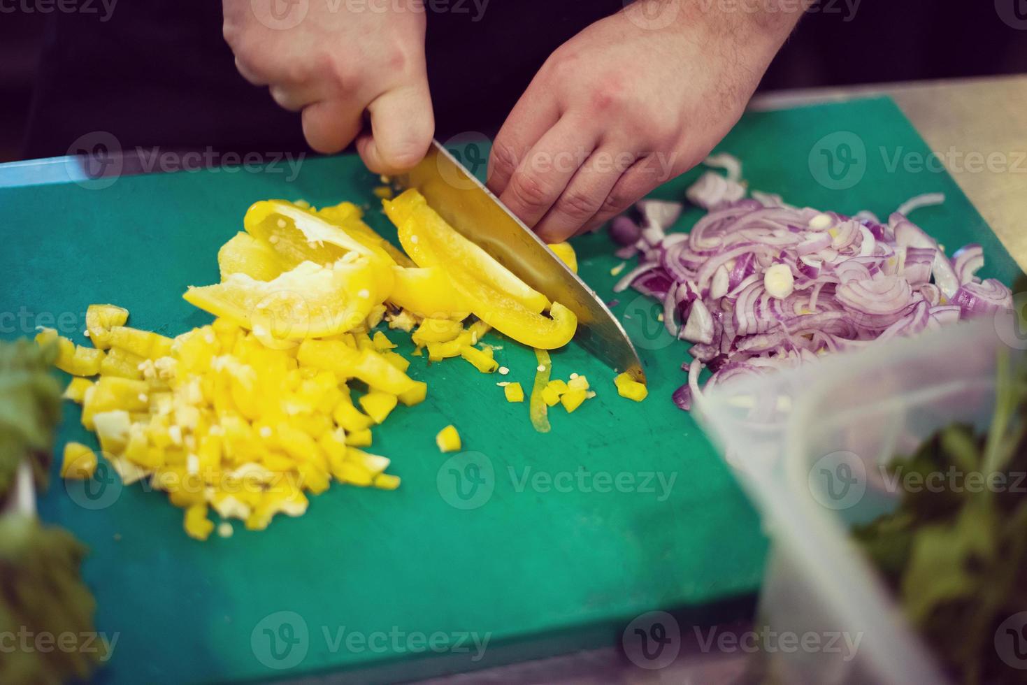 Chef hands cutting fresh and delicious vegetables photo