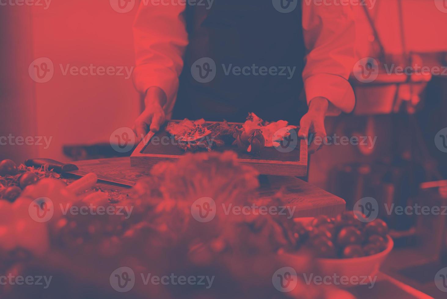 female Chef holding beef steak plate photo