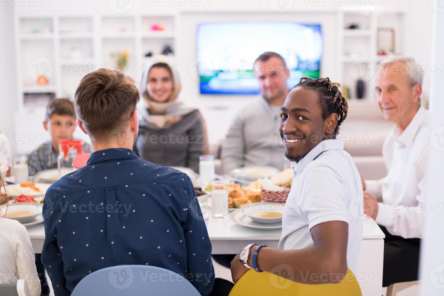 black man enjoying iftar dinner with family photo