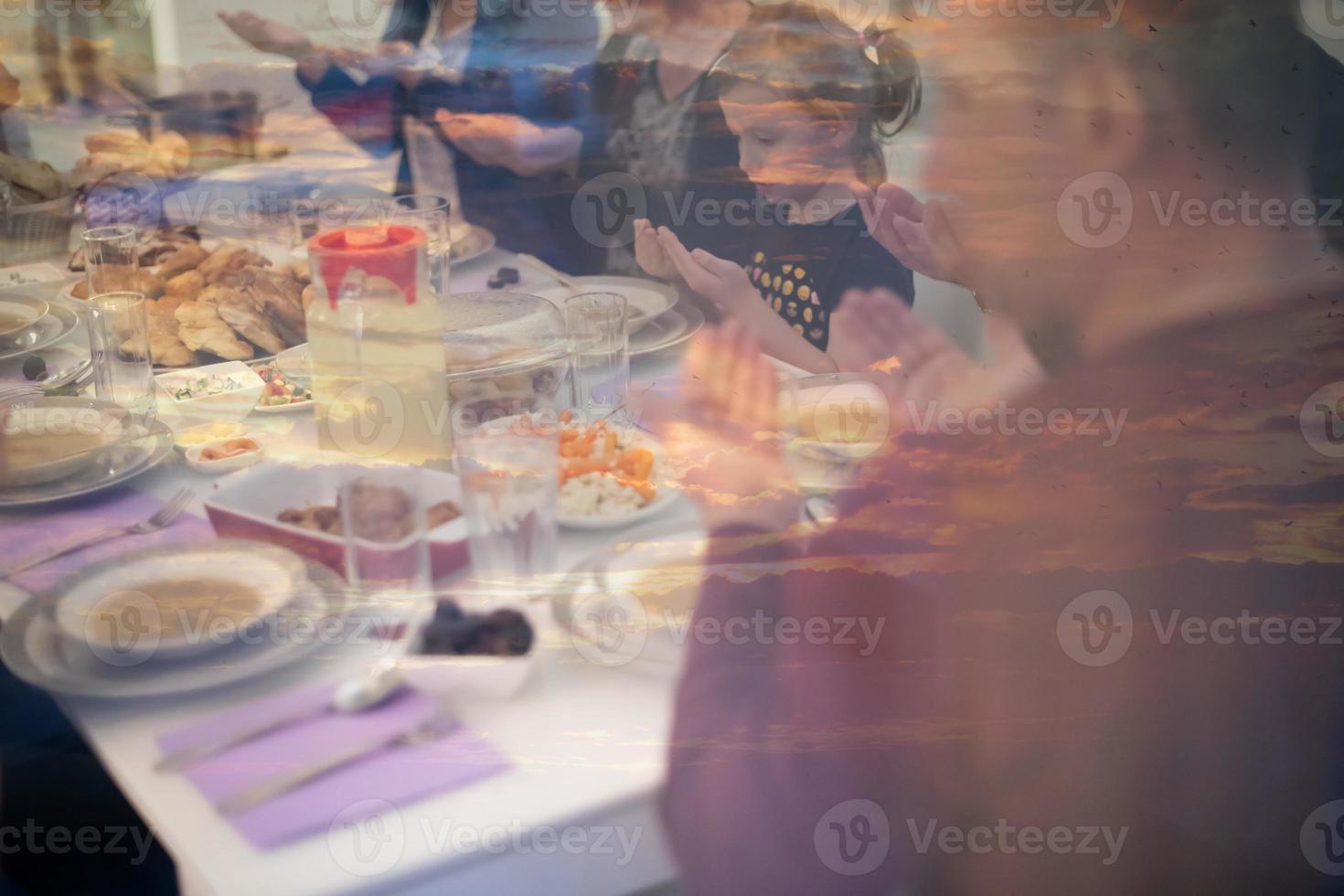 Eid Mubarak  Islamic family praying before halal Iftar dinner photo