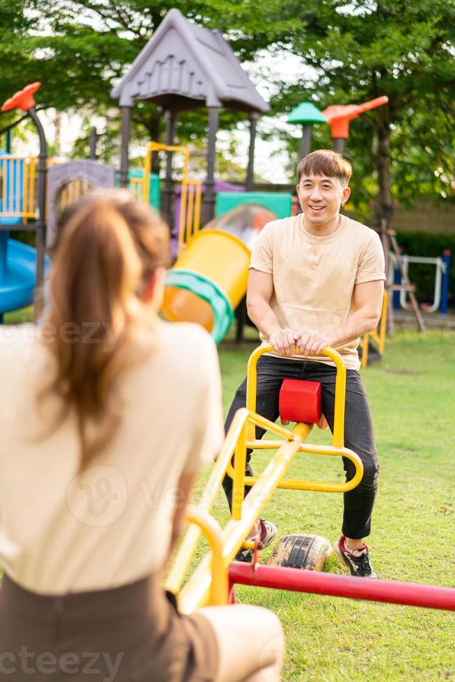 Asian couple love play seesaw photo