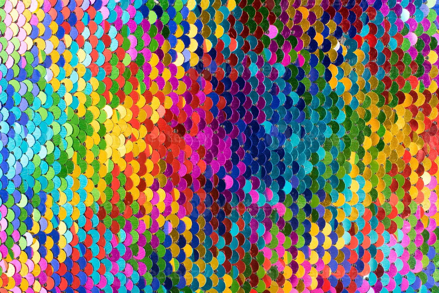 Sequins background. Multicolored sequins. Background with shiny sequins on fabric. photo