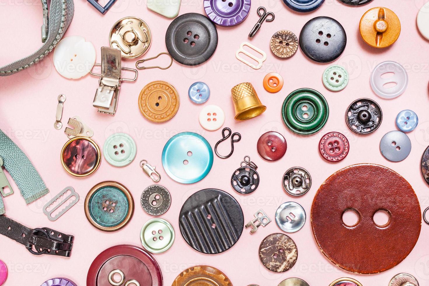 many various sewing items on pink background photo