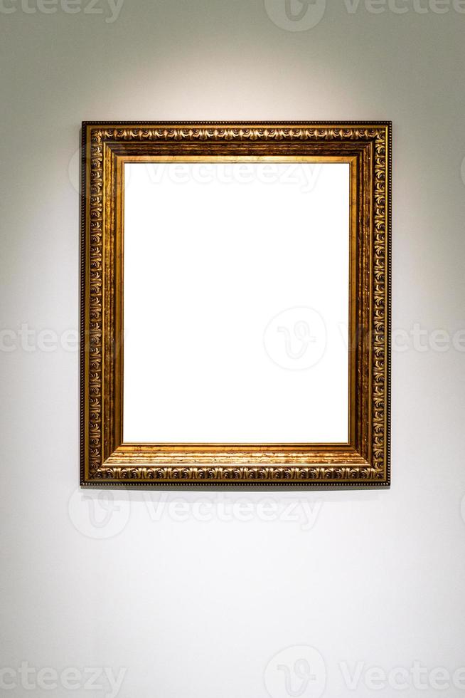 vertical classic golden picture frame on gray wall photo