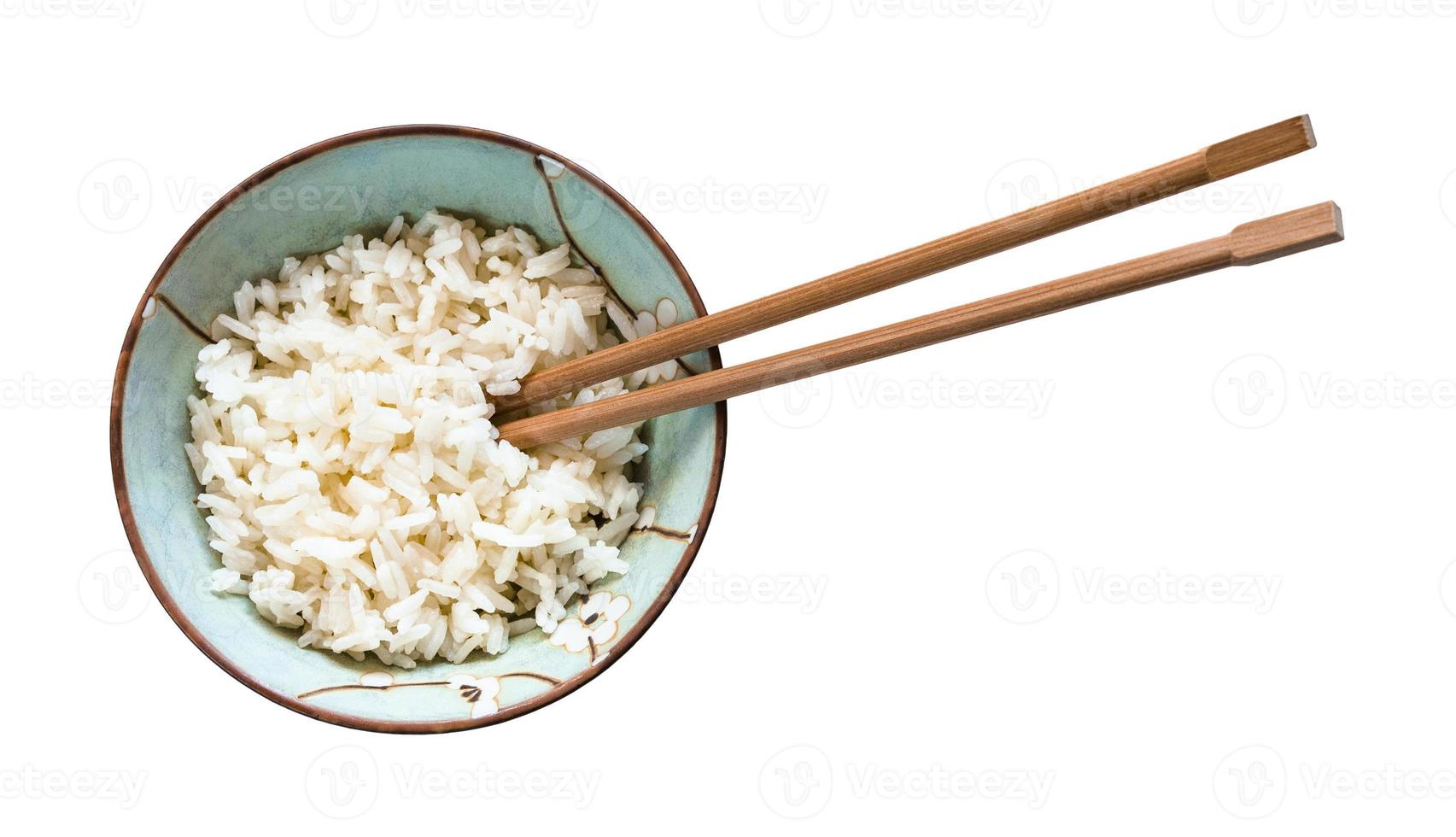 chopsticks in bowl with boiled rice isolated photo