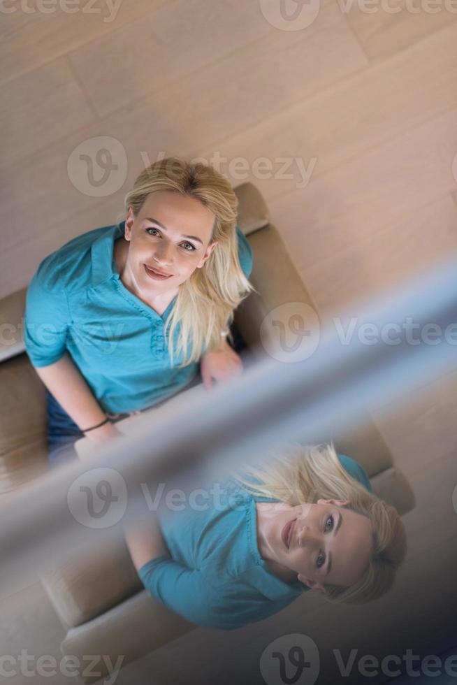 Young woman using laptop at home top view photo