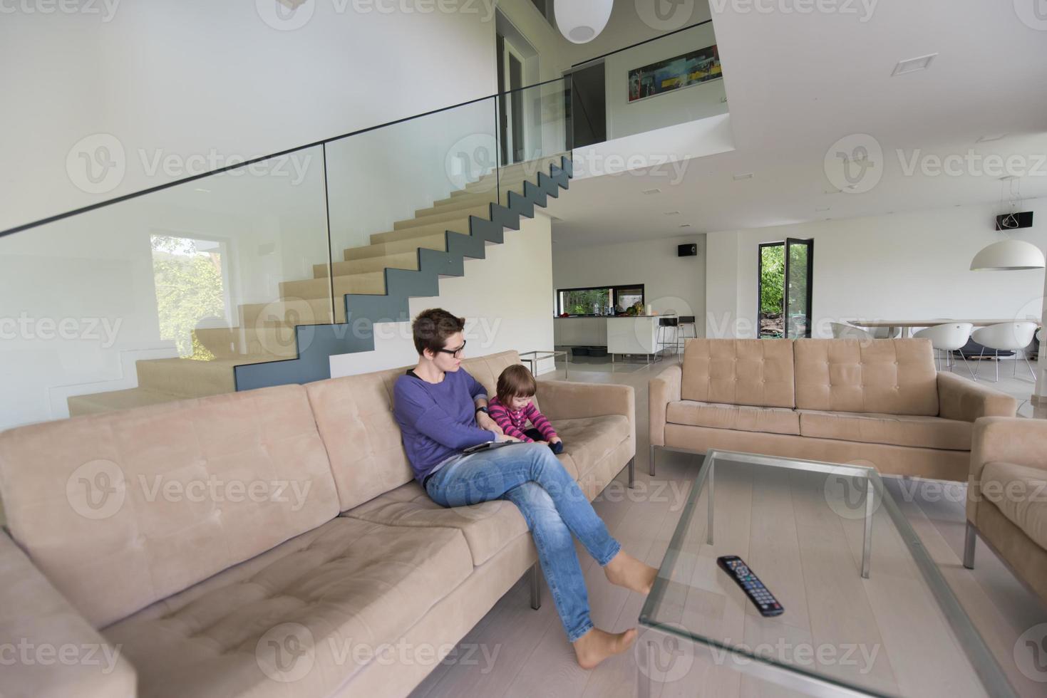 mother and her cute little daughter are using a tablet photo