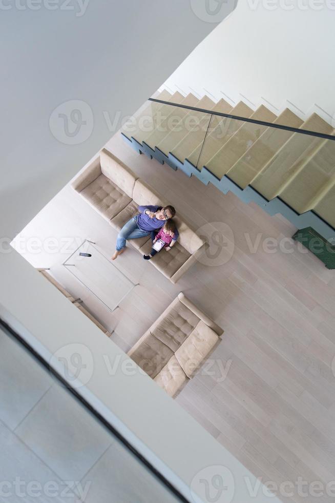 mother and her cute little daughter are using a tablet top view photo