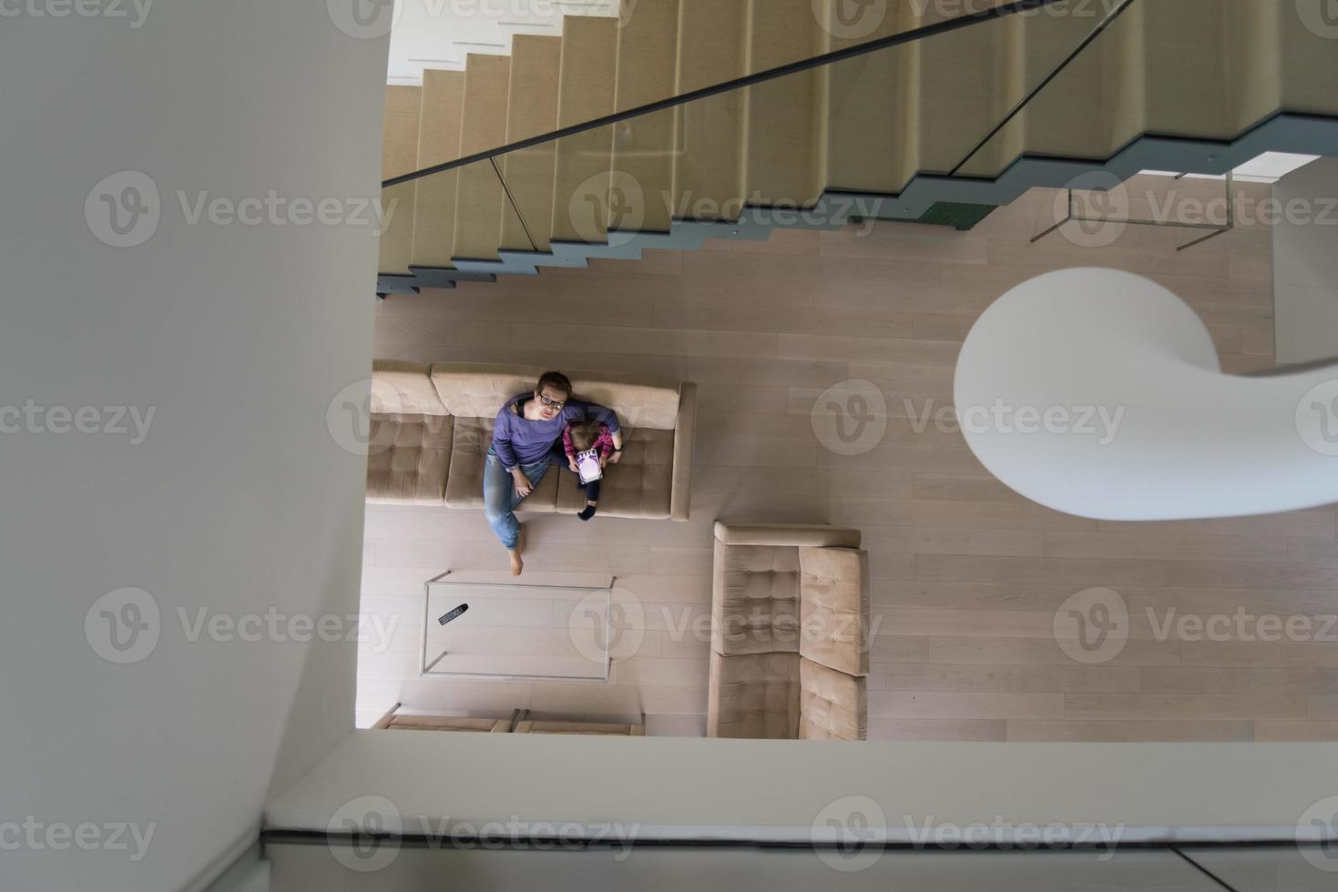mother and her cute little daughter are using a tablet top view photo