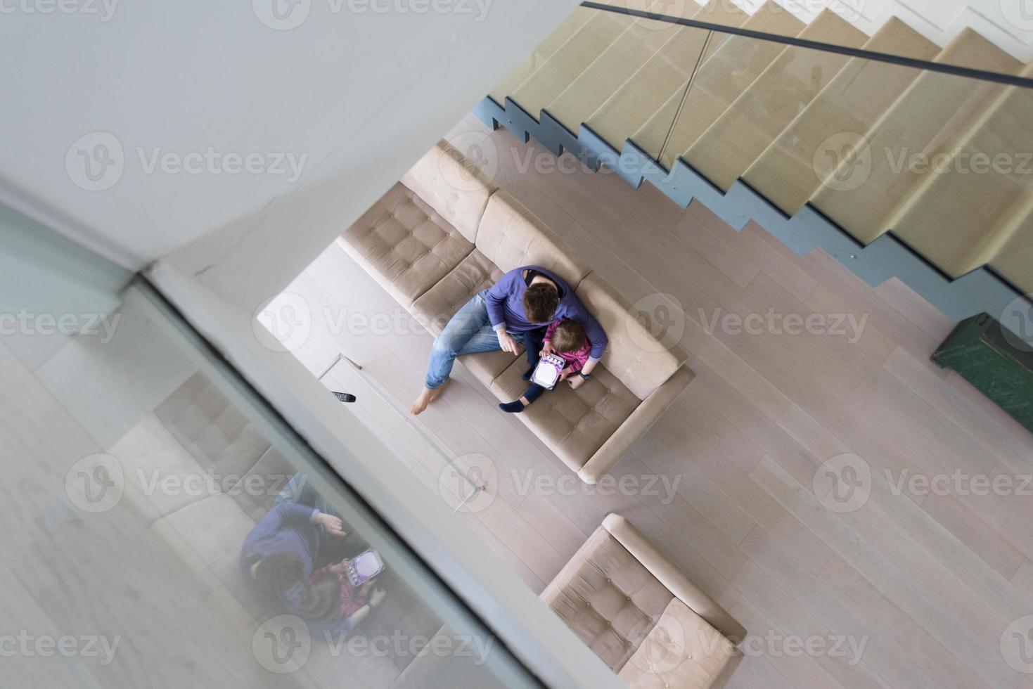 mother and her cute little daughter are using a tablet top view photo
