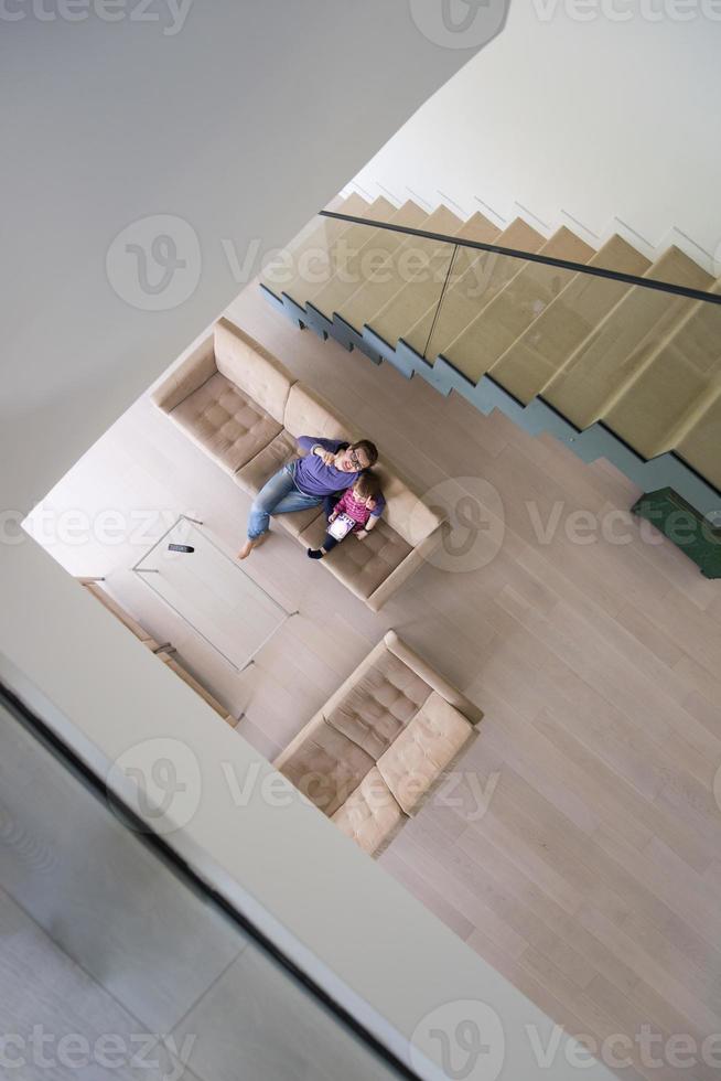 mother and her cute little daughter are using a tablet top view photo