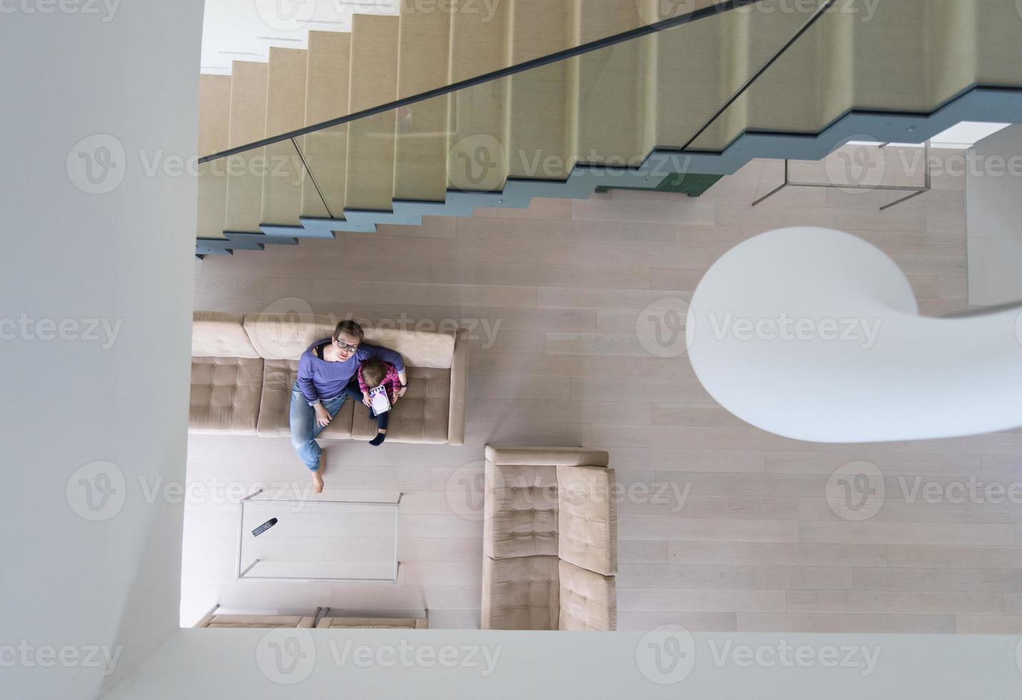 mother and her cute little daughter are using a tablet top view photo