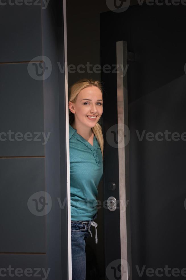 woman opening her house door photo