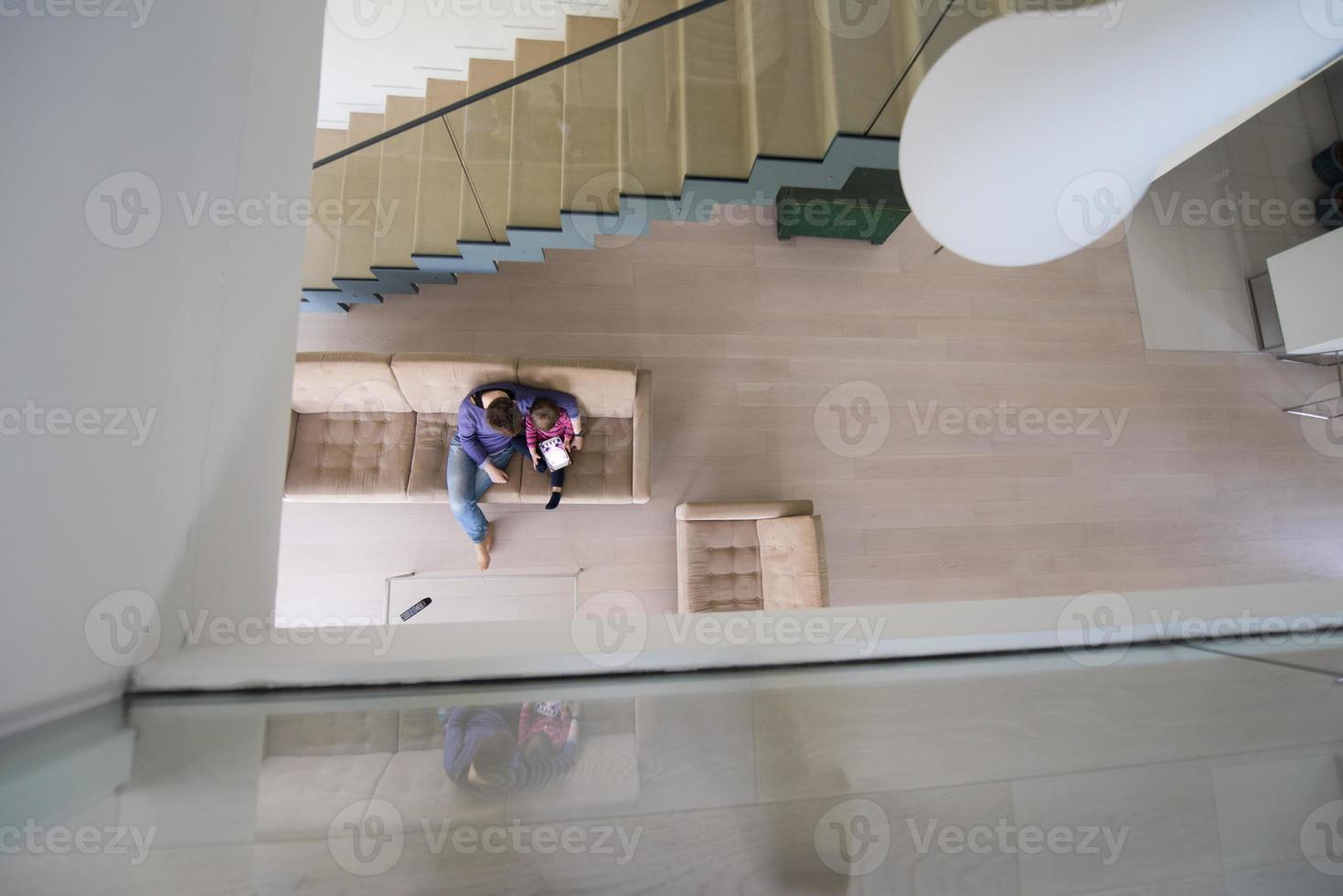 mother and her cute little daughter are using a tablet top view photo