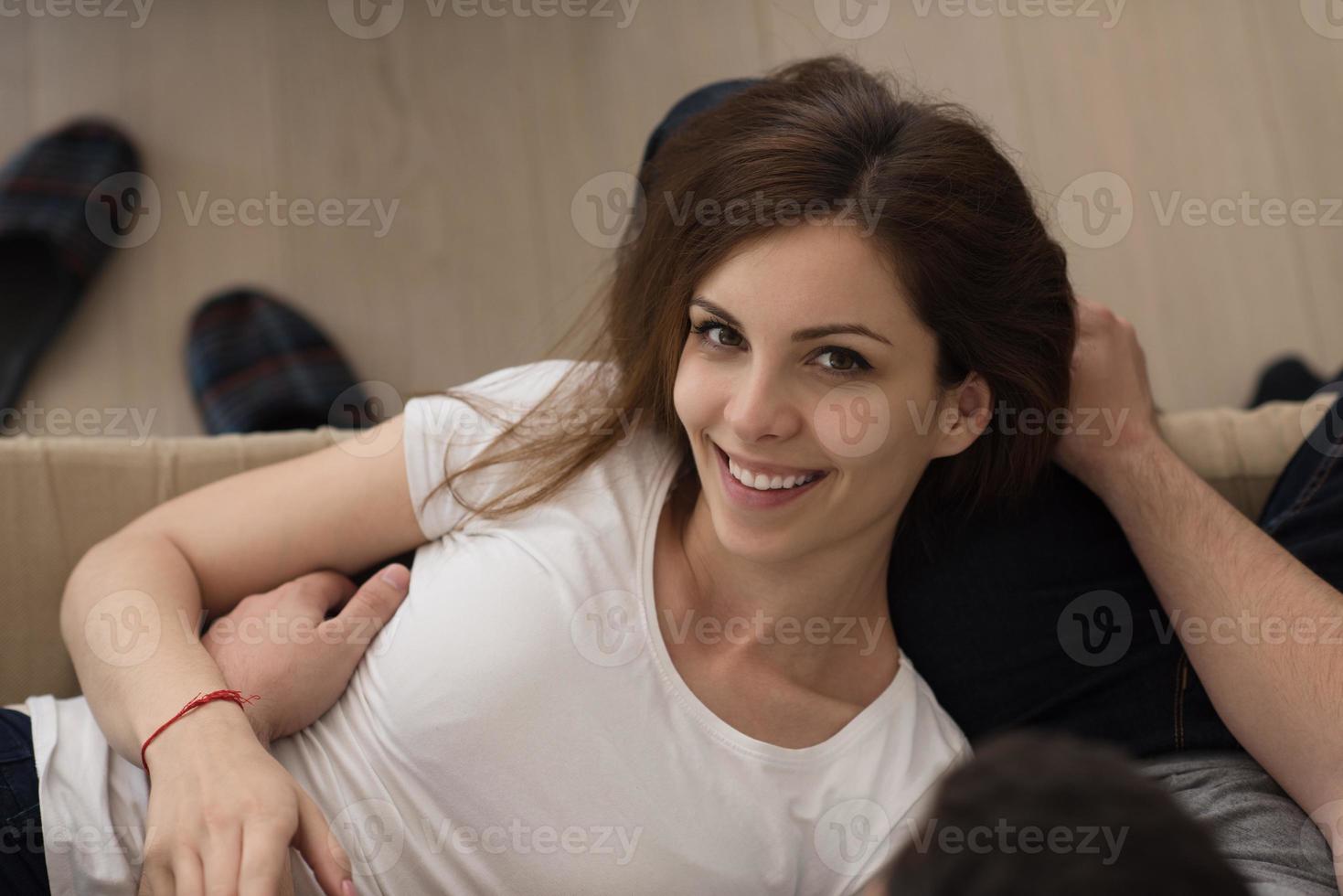 young handsome couple hugging on the sofa photo