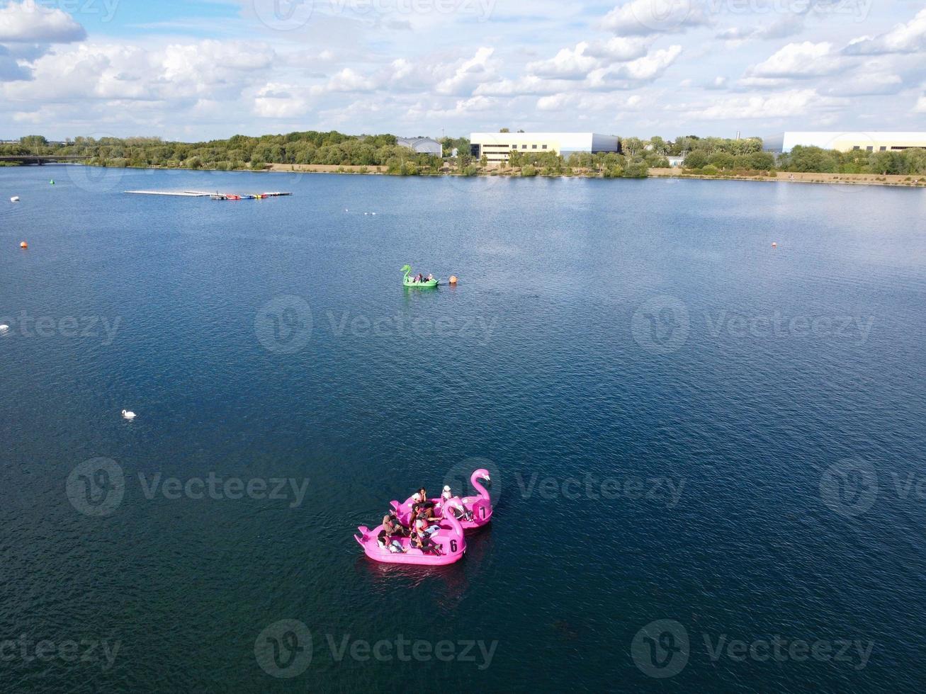 Beautiful Aerial Drone's Camera  Footage of Willen Lake and Park which is located at Milton Keynes, England. People are Enjoying at Lake on a Hot Sunny Day of Summer photo