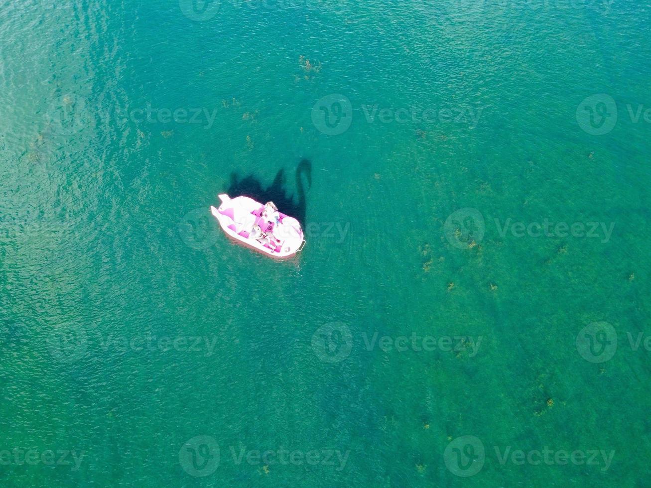 Beautiful Aerial Drone's Camera  Footage of Willen Lake and Park which is located at Milton Keynes, England. People are Enjoying at Lake on a Hot Sunny Day of Summer photo