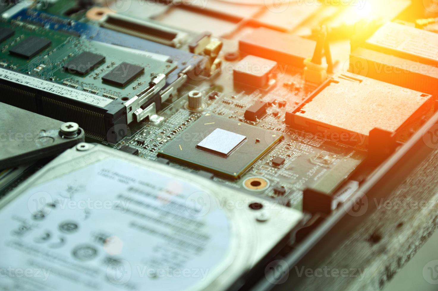 Close-up of a part of a computer motherboard, with many IC chips visible. photo