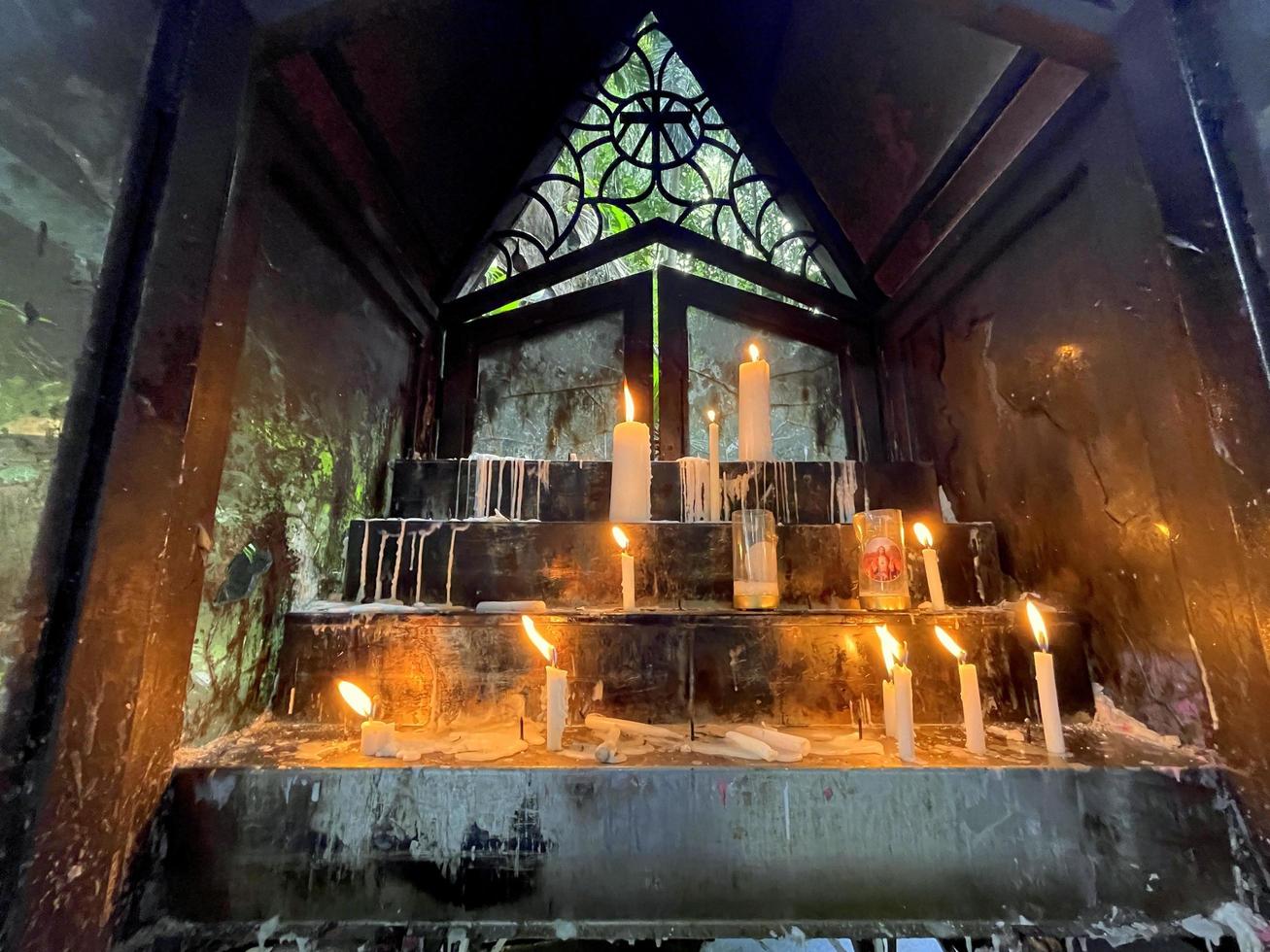 un montón de oraciones, las llamas de las velas que brillan en la oscuridad crean una atmósfera espiritual foto