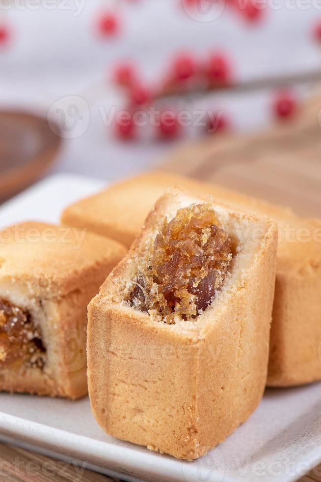 Pineapple cake pastry - Taiwanese famous sweet delicious dessert food with tea, close up, copy space design. photo