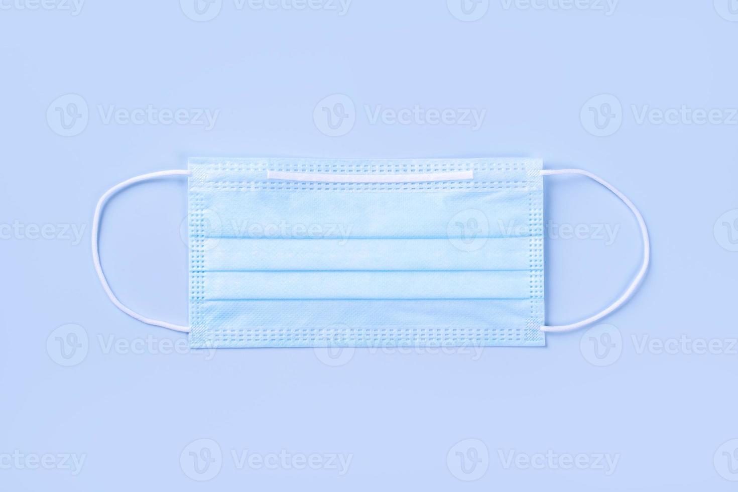 Blue mask - medical equipment with stethoscope, concept of world disease pandemic infection and prevention, top view, flat lay, overhead design photo