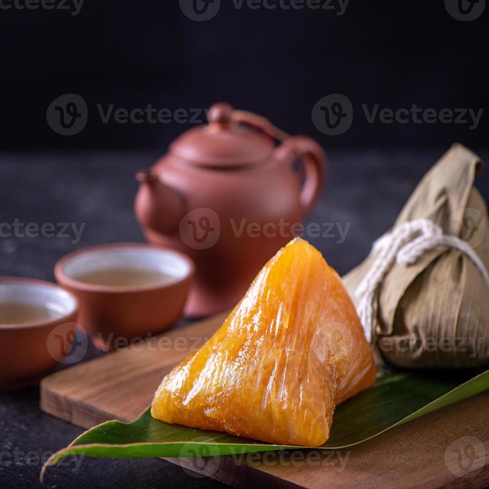 Alkaline rice dumpling zongzi - Traditional sweet Chinese crystal food on a plate to eat for Dragon Boat Duanwu Festival celebration concept, close up. photo