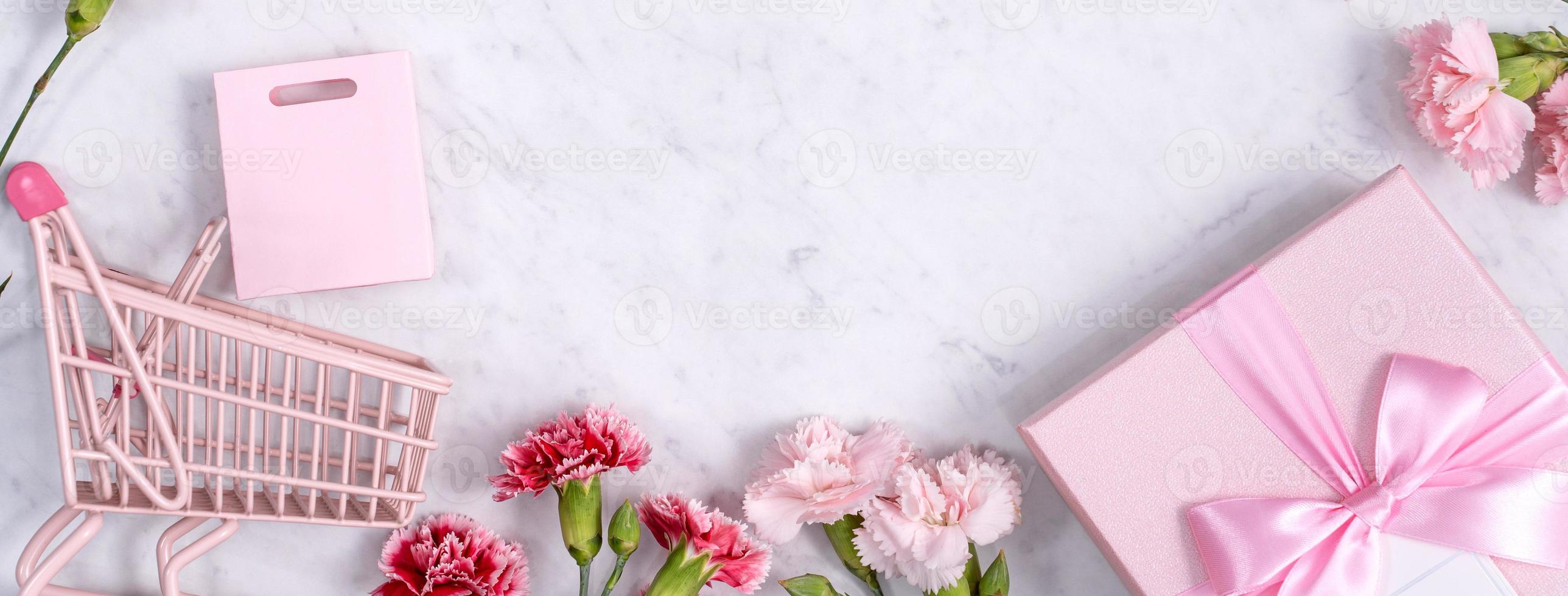 Mother's Day, Valentine's Day background design concept, beautiful pink, red carnation flower bouquet on marble table, top view, flat lay, copy space. photo
