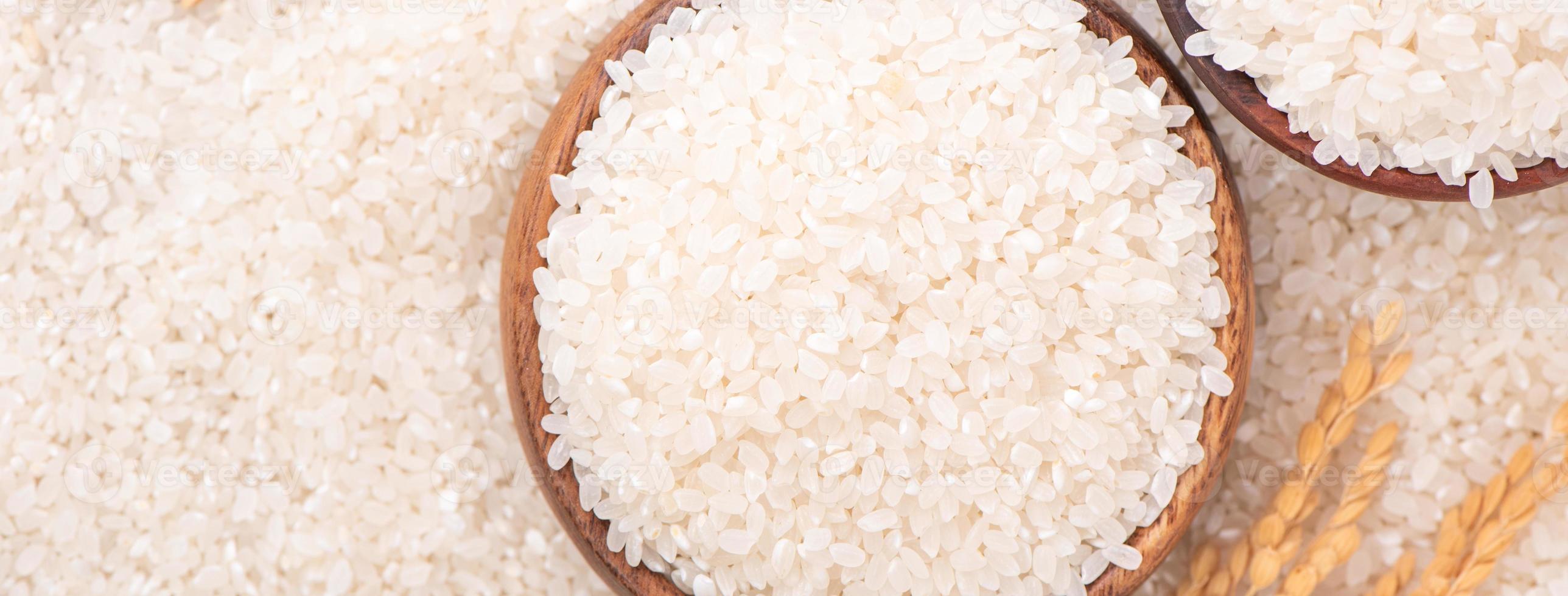 Raw rice in a bowl and full frame in the white background table, top view overhead shot, close up photo