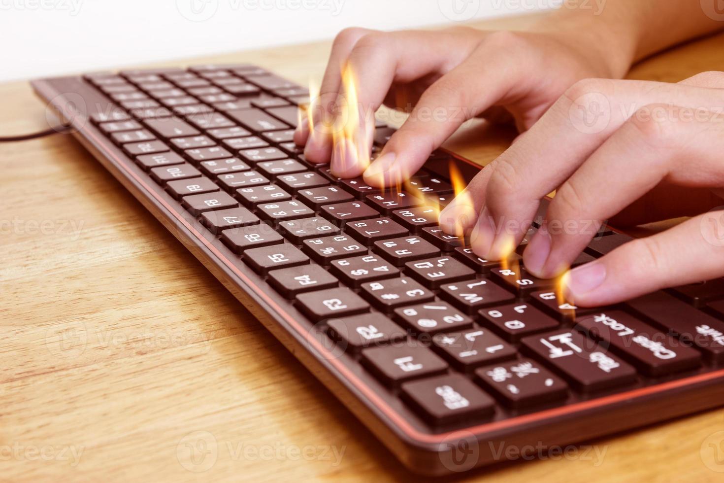 Close up of typing male hands on black keyboard,Businessman working concept,flame effect photo