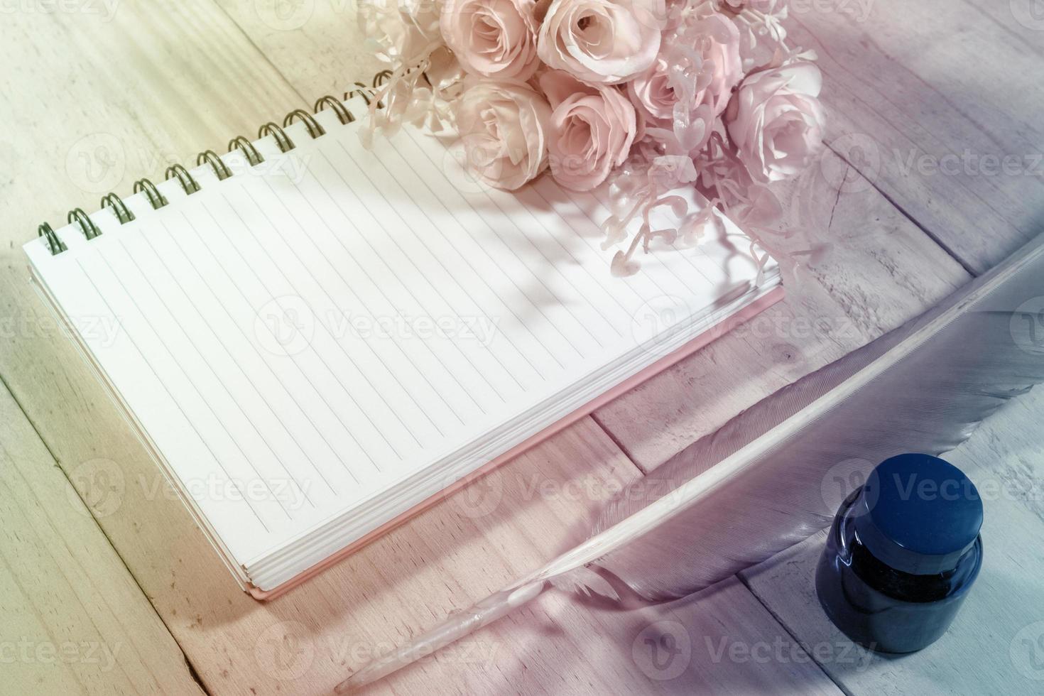 open note book with feather pen,filter effect. photo