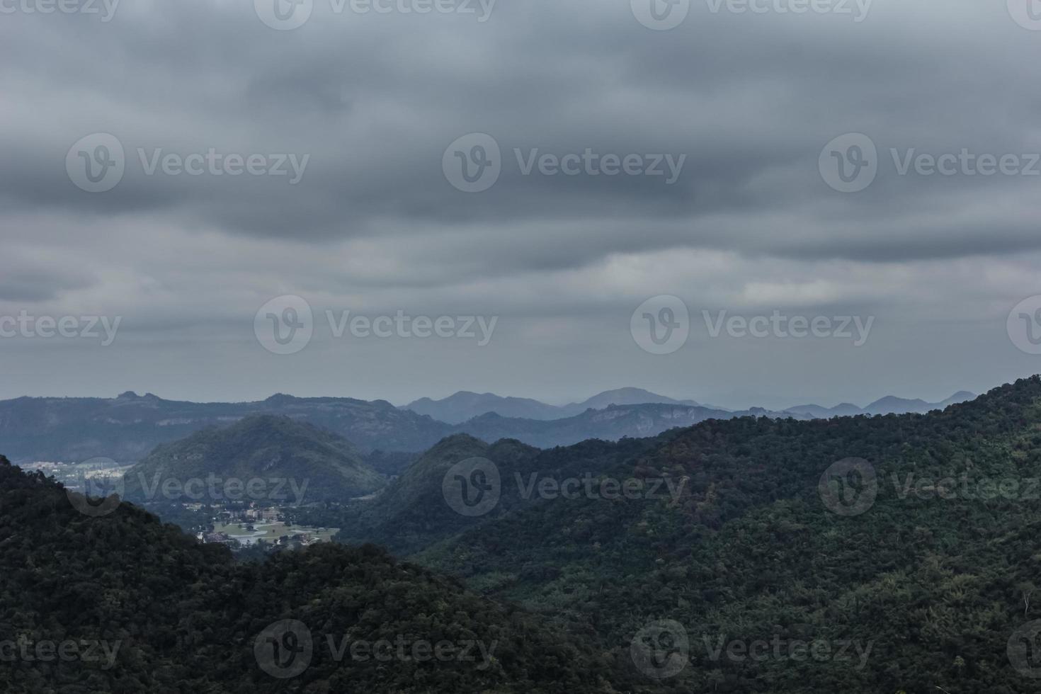 mountain peak landscape with clouds and rain. photo
