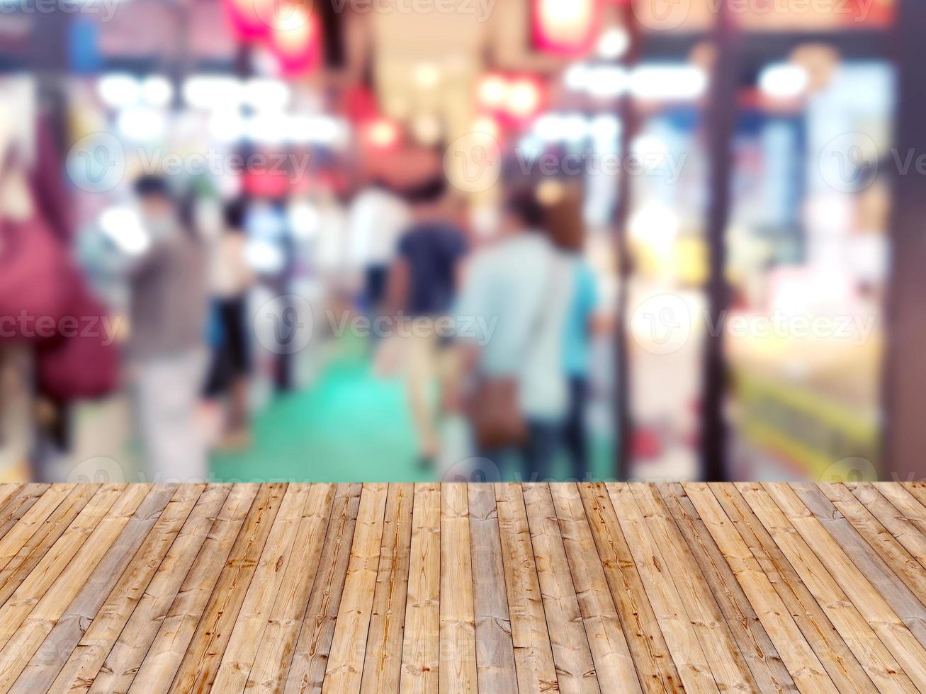 Wooden table with shopping mall blurred background photo