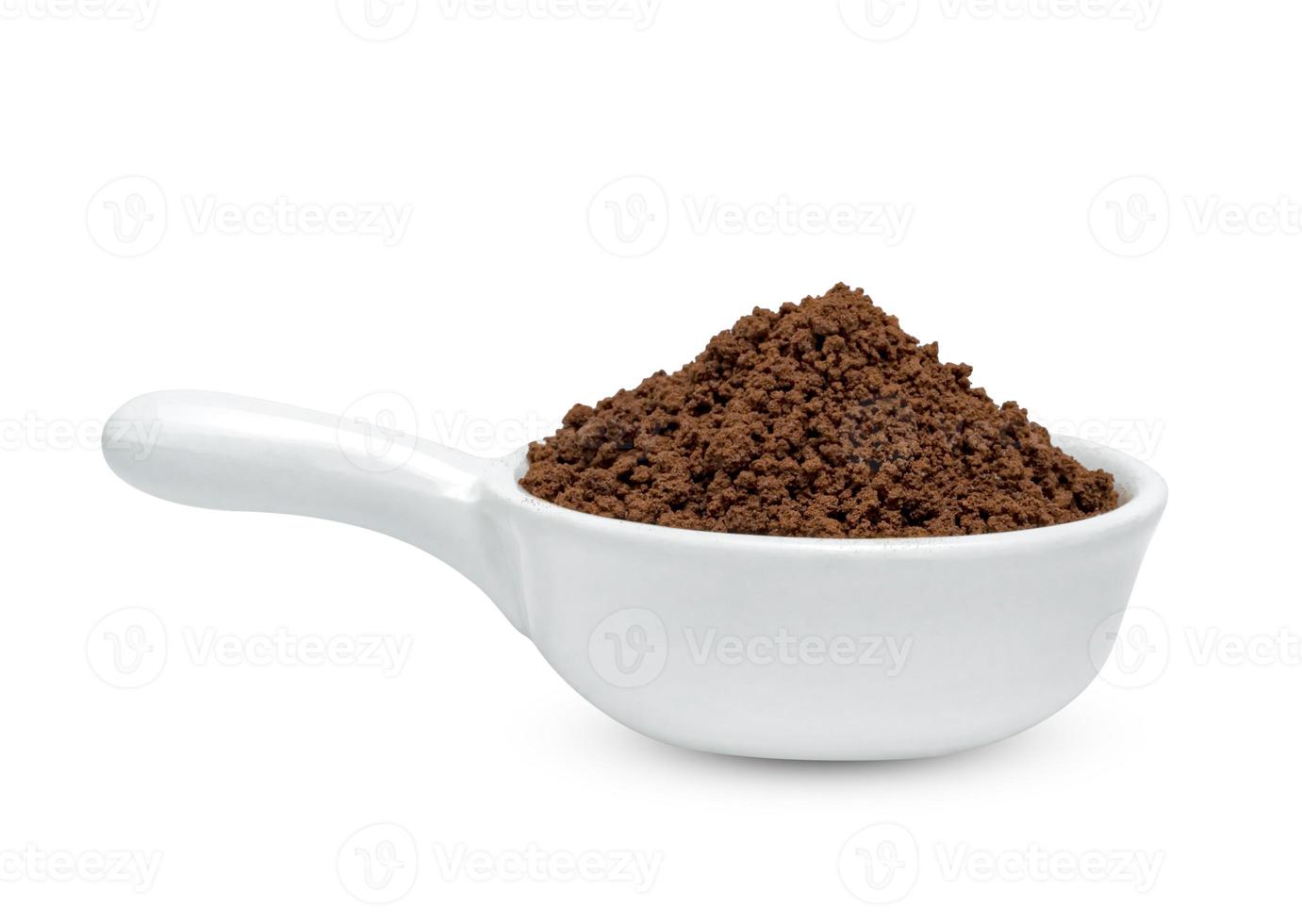 Instant coffee powder with ceramic spoon isolated on white background ,include clipping path photo