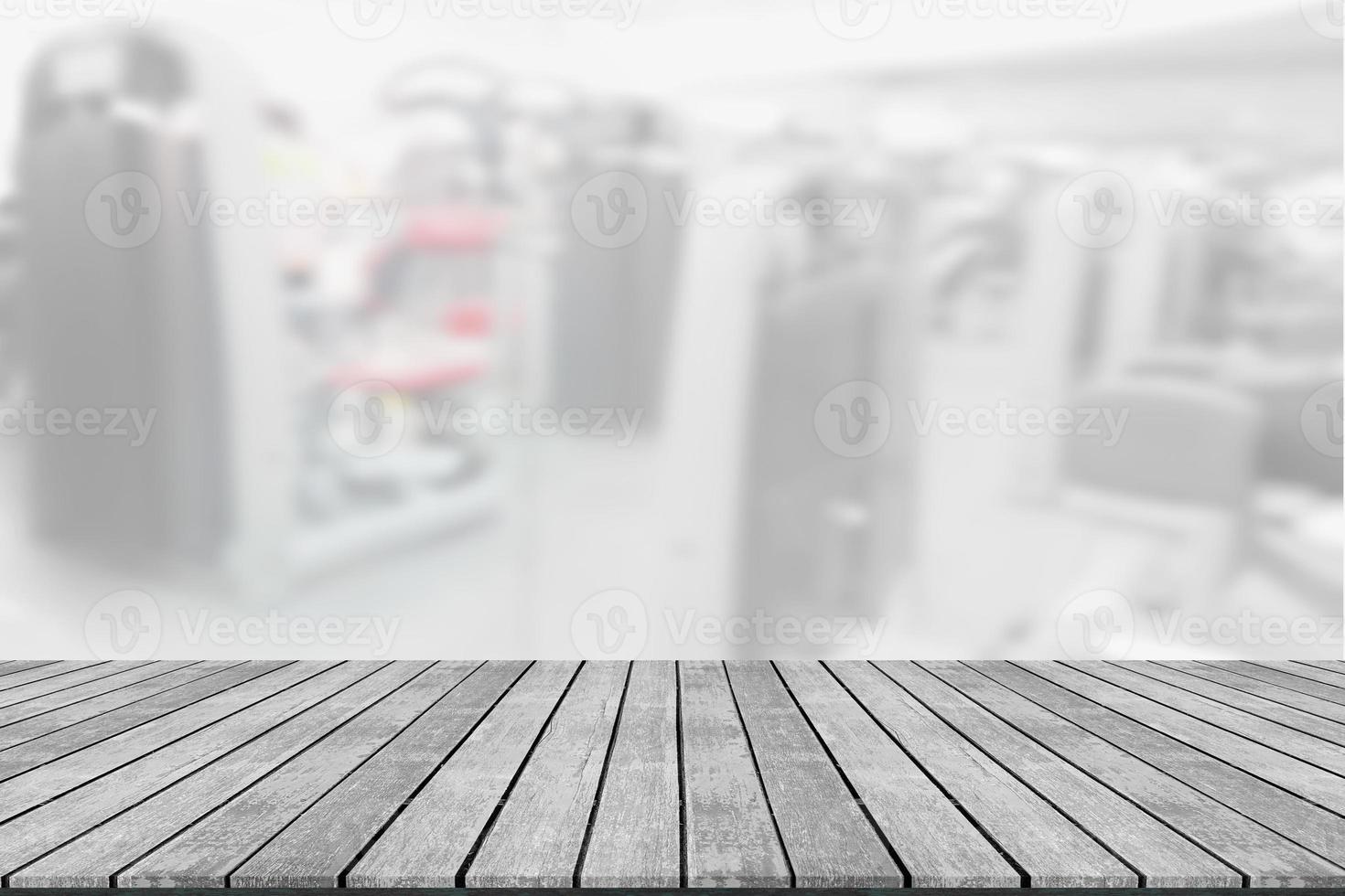 Empty wooden board space platform with blur fitness gym equipment background photo