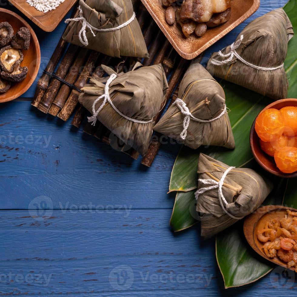 zongzi - Dragon Boat Festival concept Rice dumpling, traditional Chinese food on blue wooden background for Duanwu Festival, top view, flat lay design concept. photo