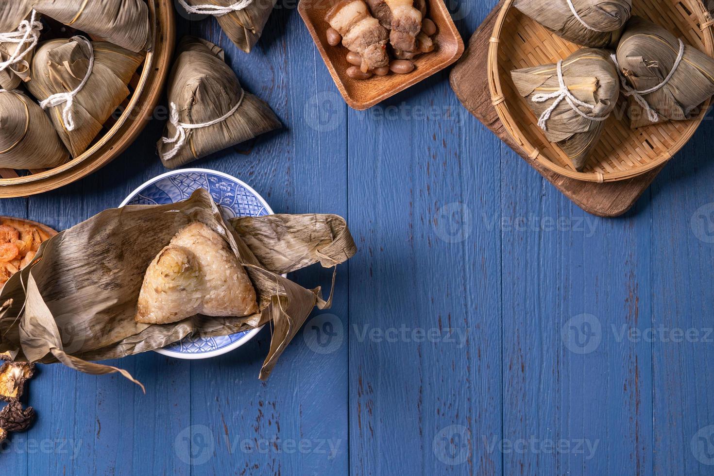 zongzi - Dragon Boat Festival concept Rice dumpling, traditional Chinese food on blue wooden background for Duanwu Festival, top view, flat lay design concept. photo