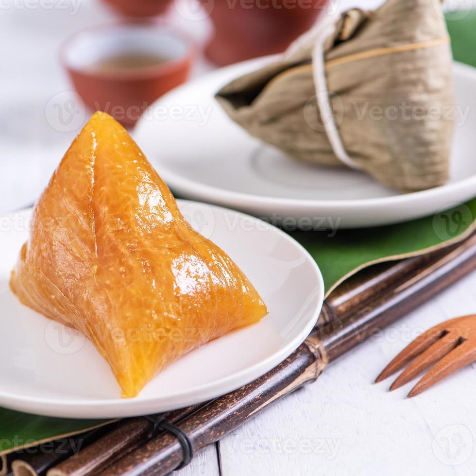 Zongzi - alkaline Chinese rice dumpling crystal food on a plate to eat for traditional Dragon Boat Duanwu Festival concept, close up. photo