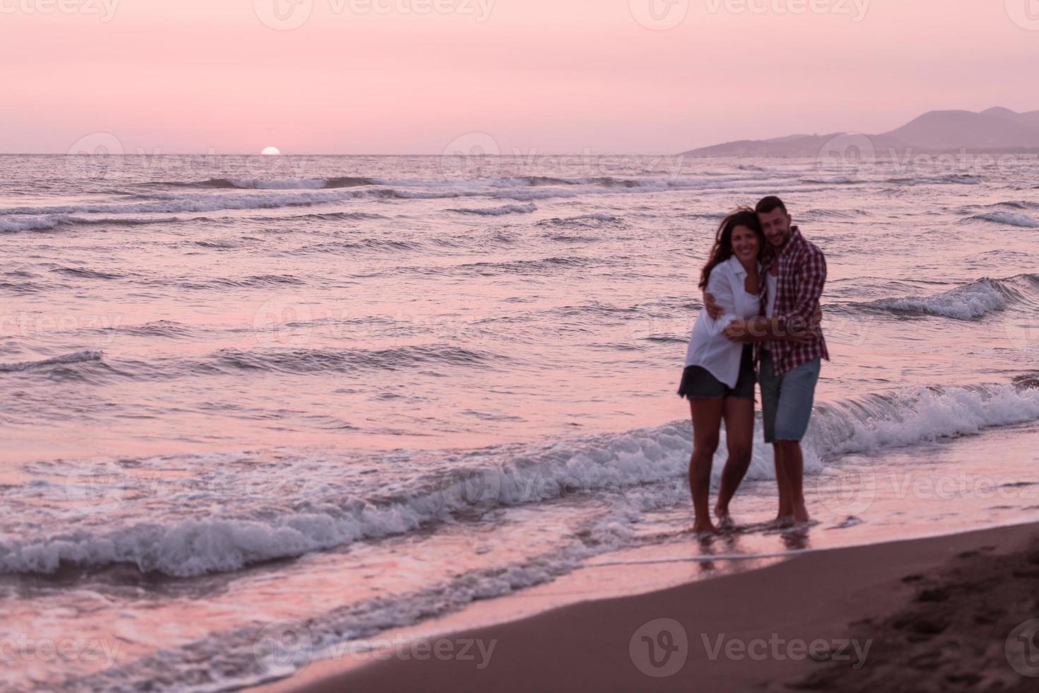 Happy Romantic Middle Aged Couple Enjoying Beautiful Sunset Walk on the Beach. Travel Vacation Retirement Lifestyle Concept photo