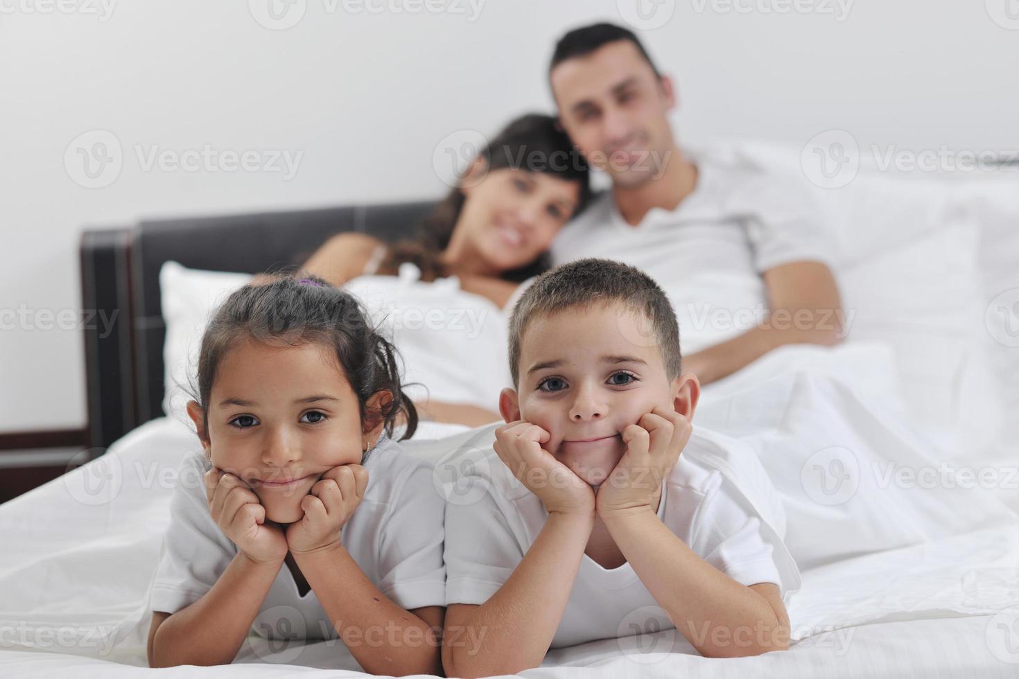 happy young Family in their bedroom photo