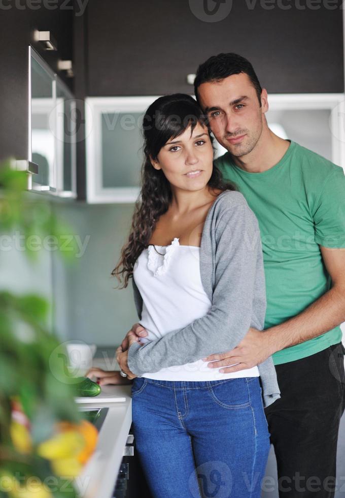 young couple have fun in modern kitchen photo