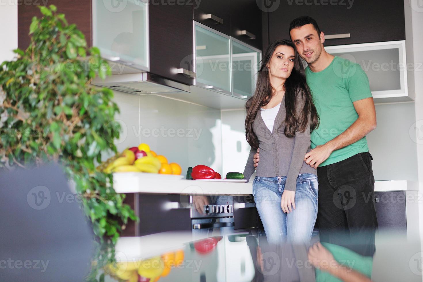 young couple have fun in modern kitchen photo